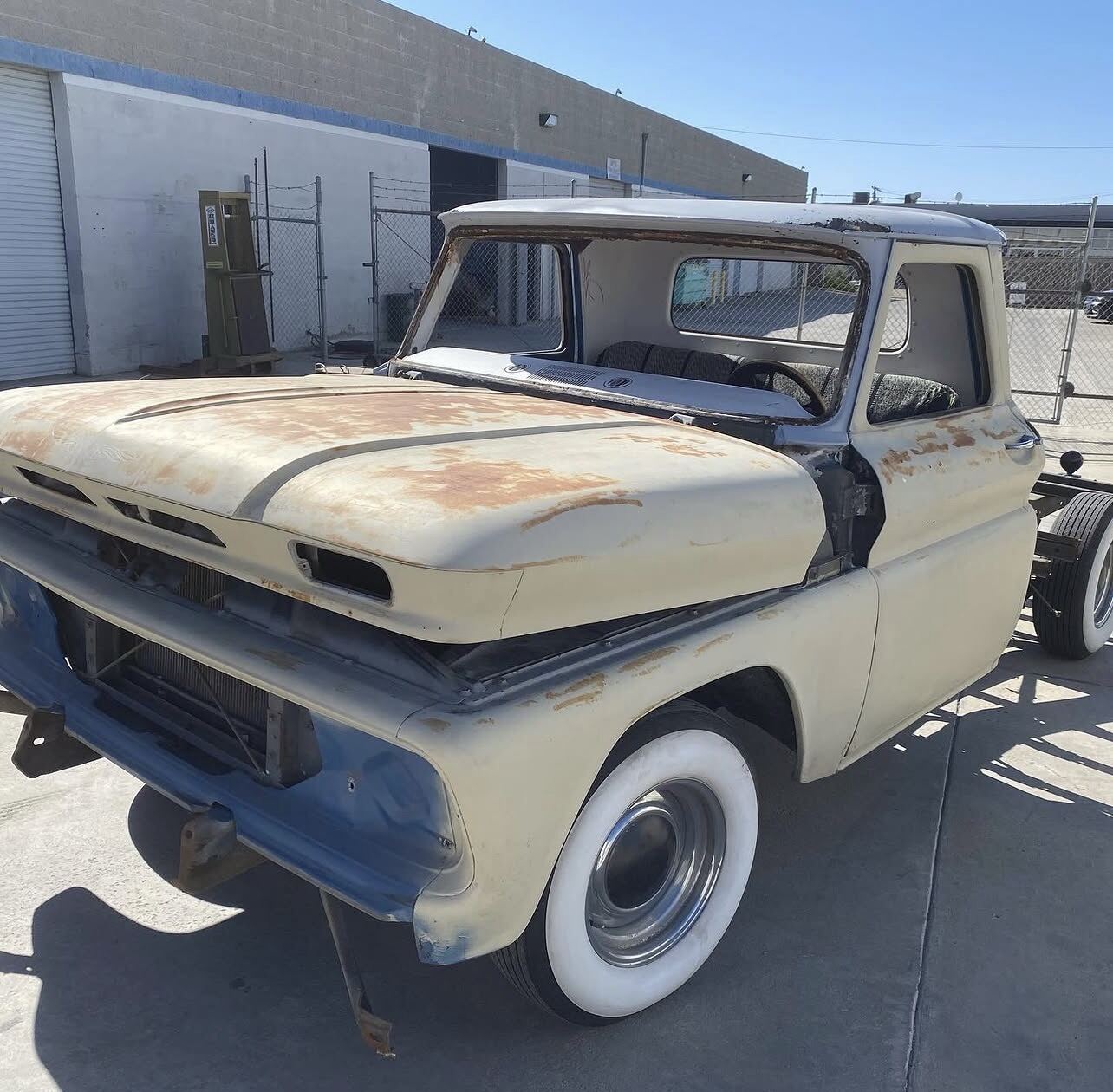 Classic pickup cab and hood with surface rust and old paint before blasting